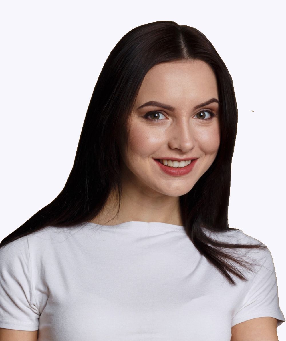 A woman with long dark hair is wearing a white shirt and smiling