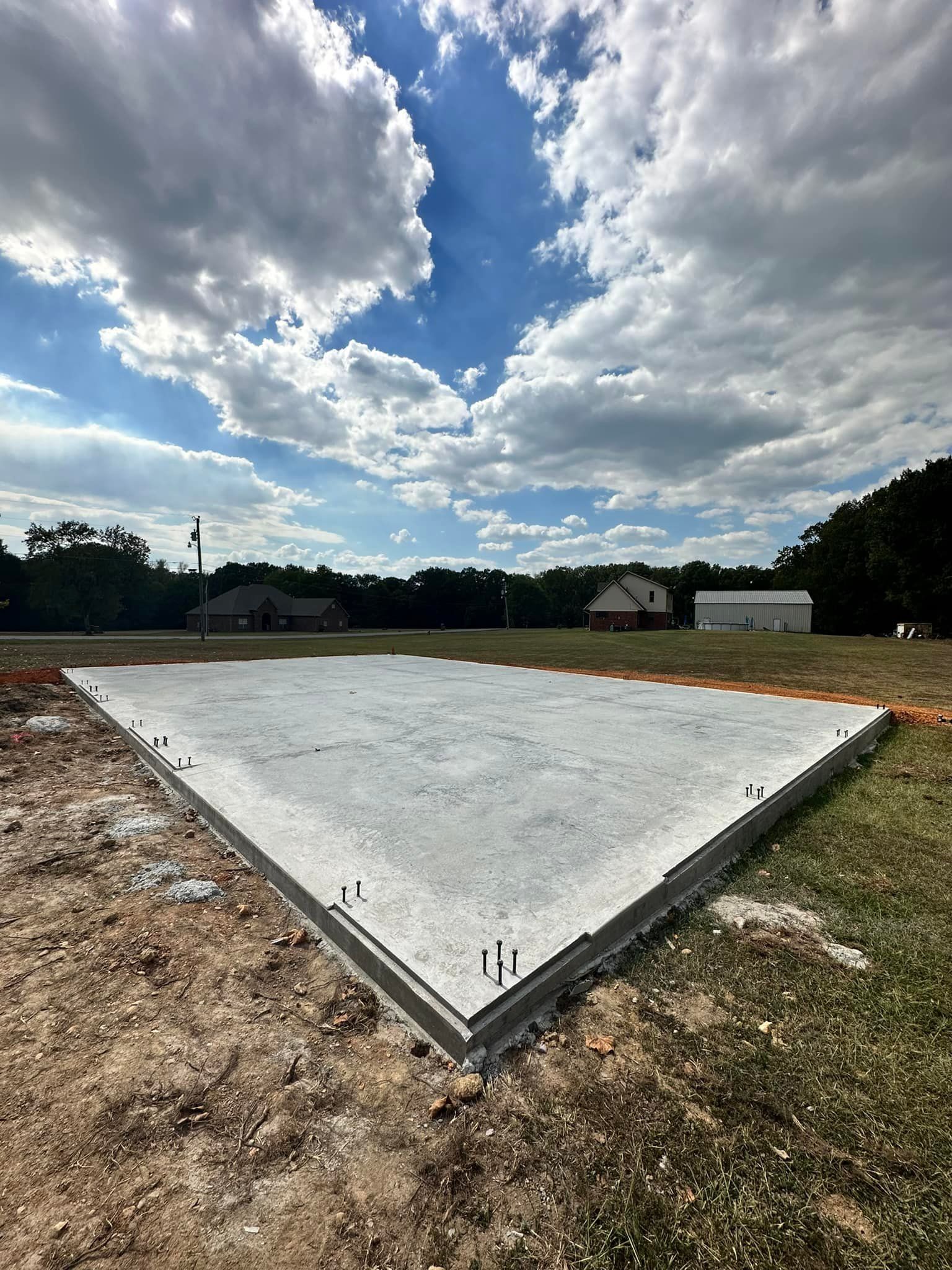 A large concrete slab is sitting in the middle of a field.