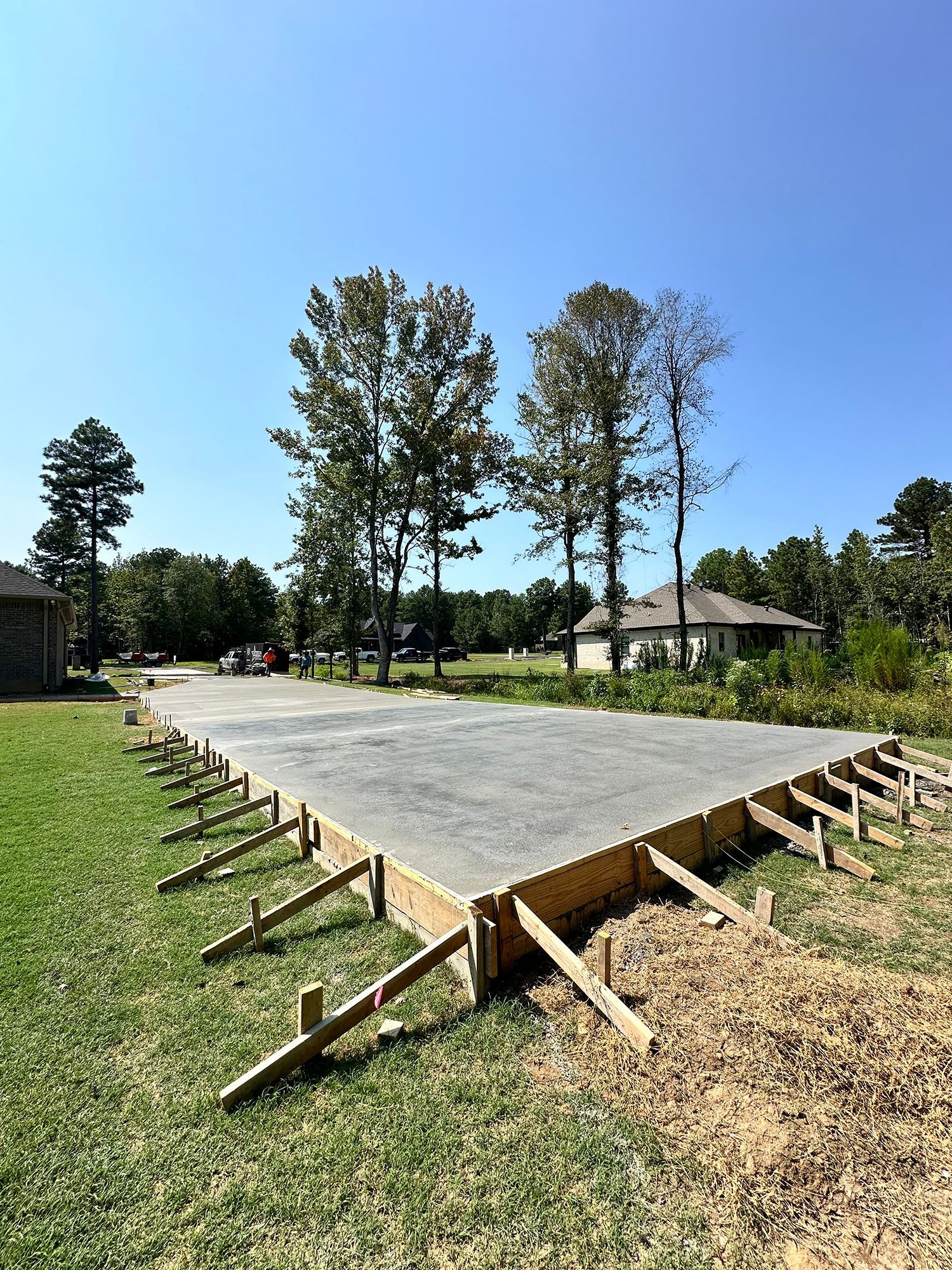 A large concrete slab is sitting on top of a lush green field.