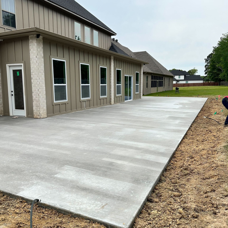 A house with a covered porch and a concrete walkway