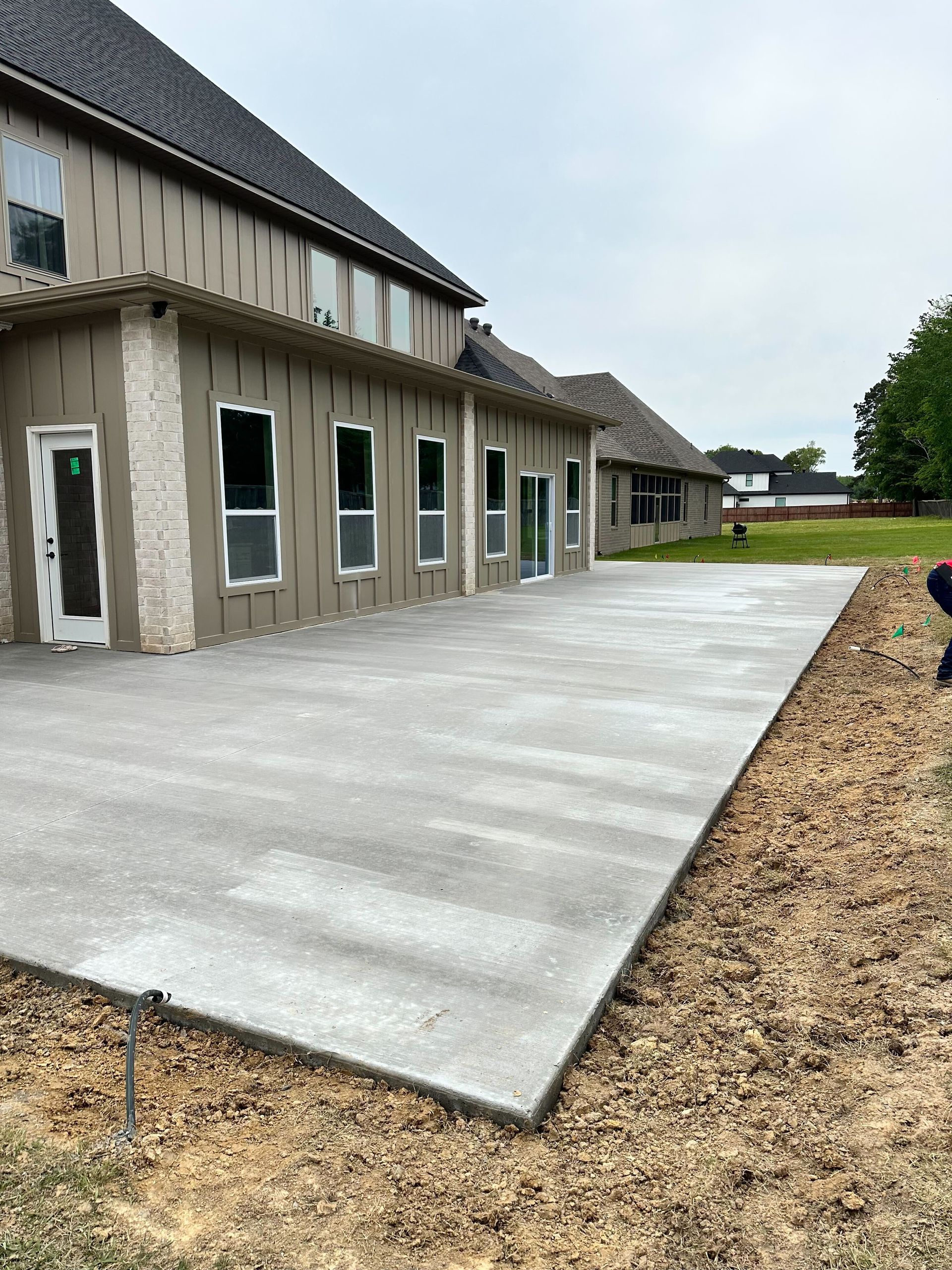A white house with a concrete driveway in front of it.