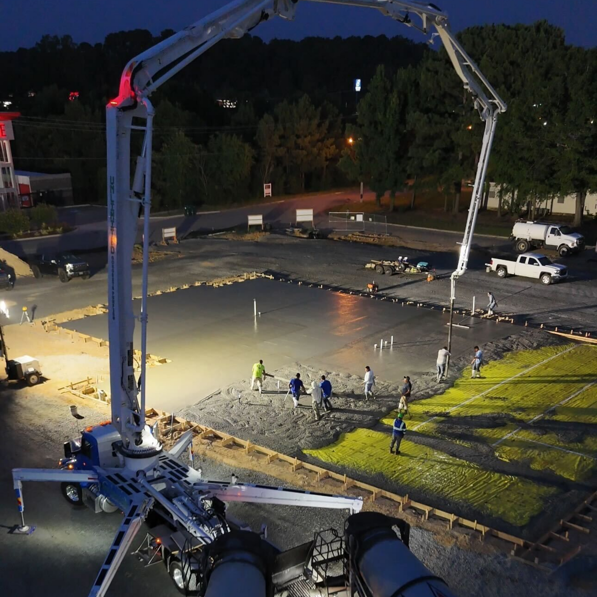 A house with a wooden fence and a concrete walkway leading to it