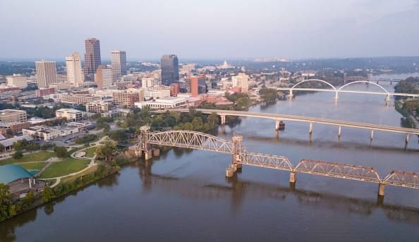 A museum building with a log cabin in front of it.