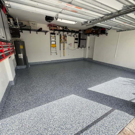 A large concrete slab is sitting in the middle of a dirt field with trees in the background.