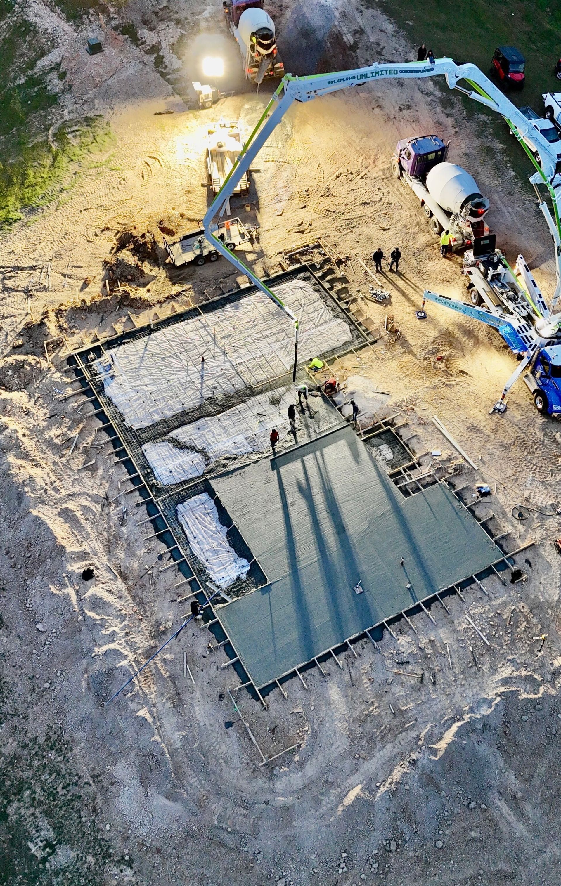 A concrete foundation is being built on a construction site.