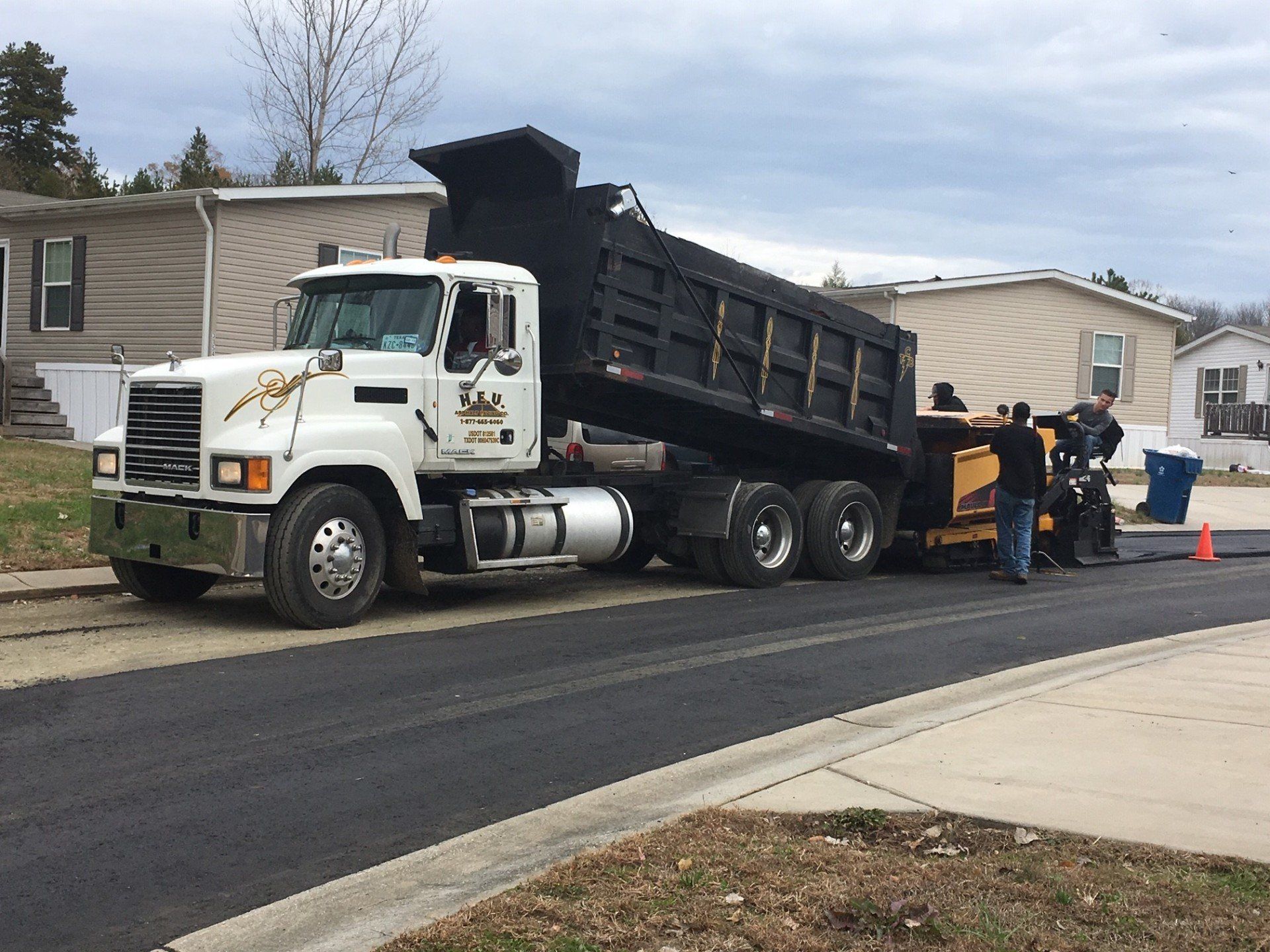 A dump truck is parked on the side of the road