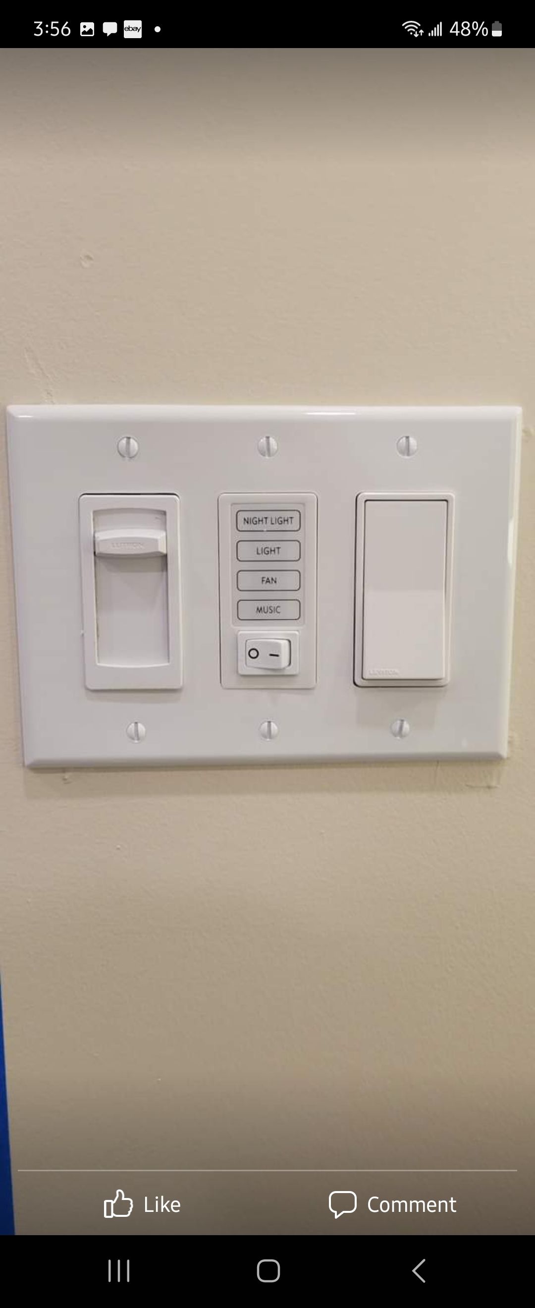 A picture of a light switch on a wall.