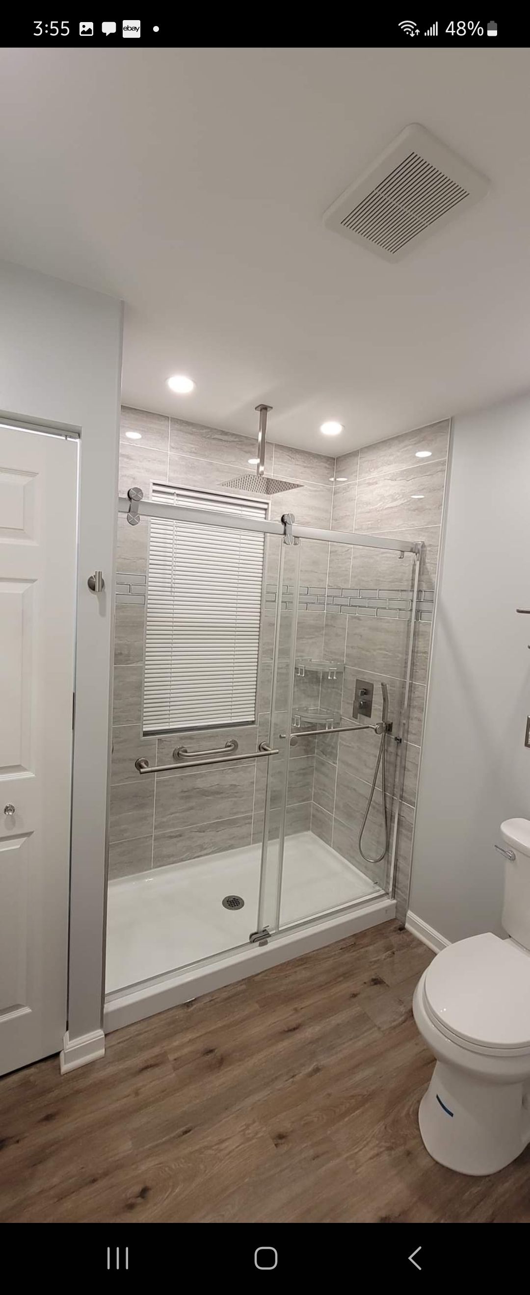 A bathroom with a walk in shower and a toilet.