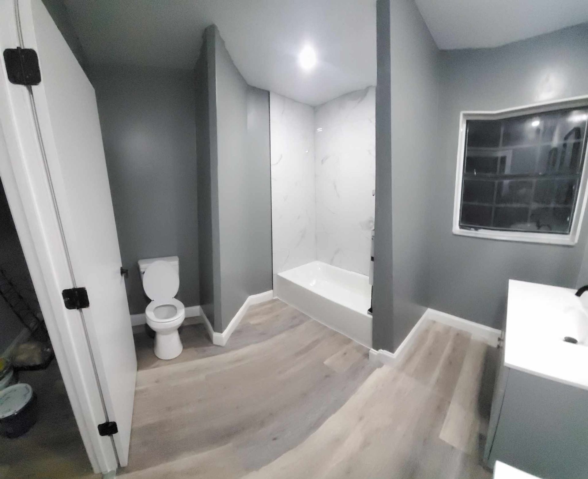 A bathroom with a toilet , sink , and shower.