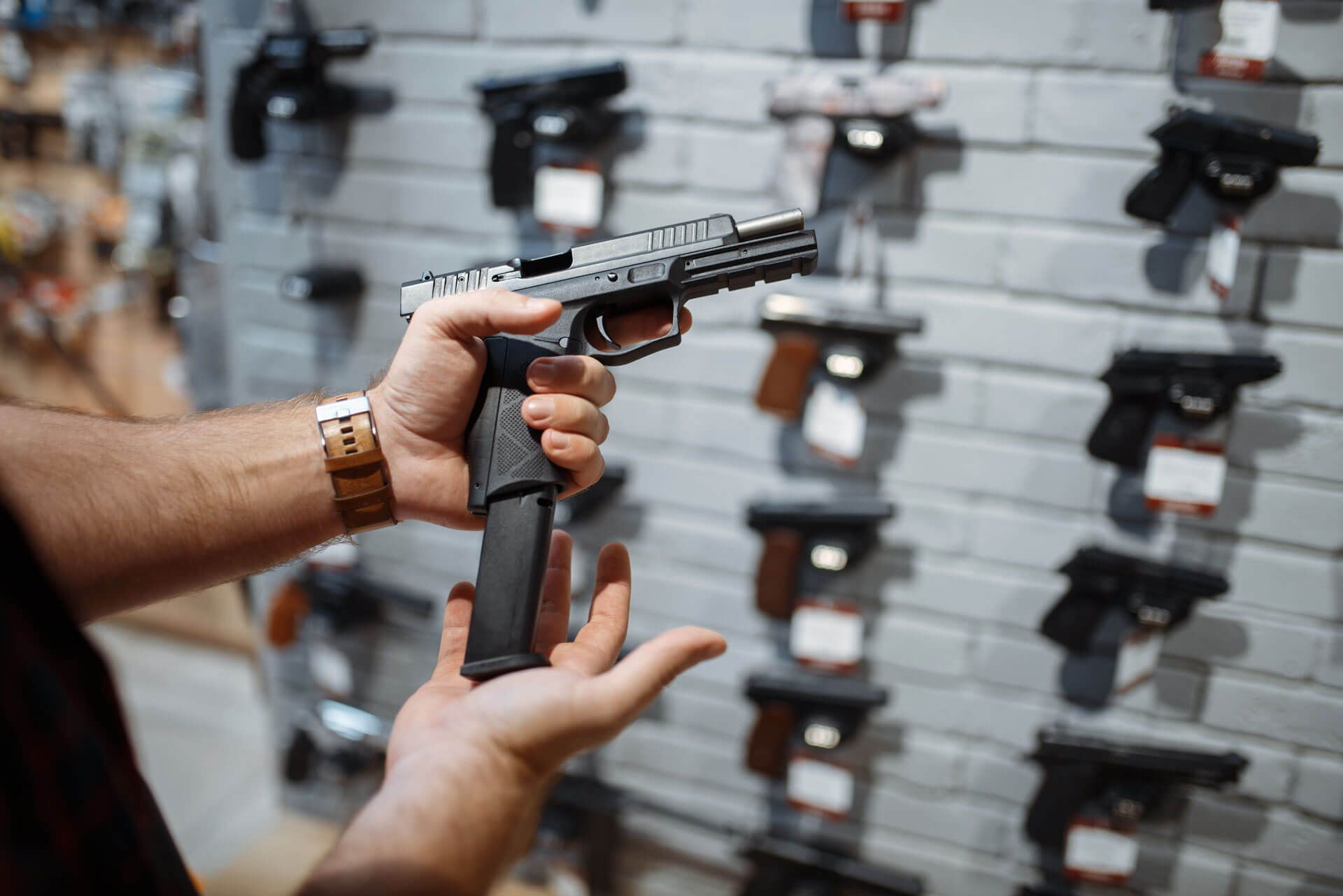 Man Grips a Firearm