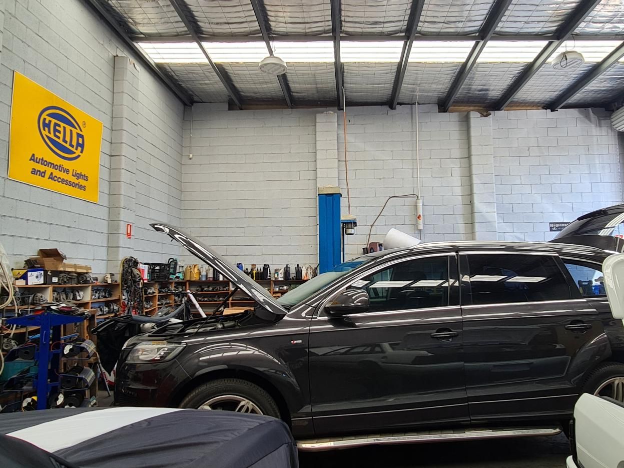 A Car is Being Worked on in a Garage With the Hood Open — Regional Auto Electrics In Fairy Meadow, NSW