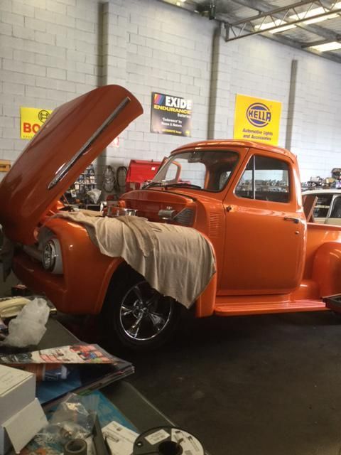 An Orange Truck With the Hood Up in a Garage — Regional Auto Electrics In Corrimal, NSW