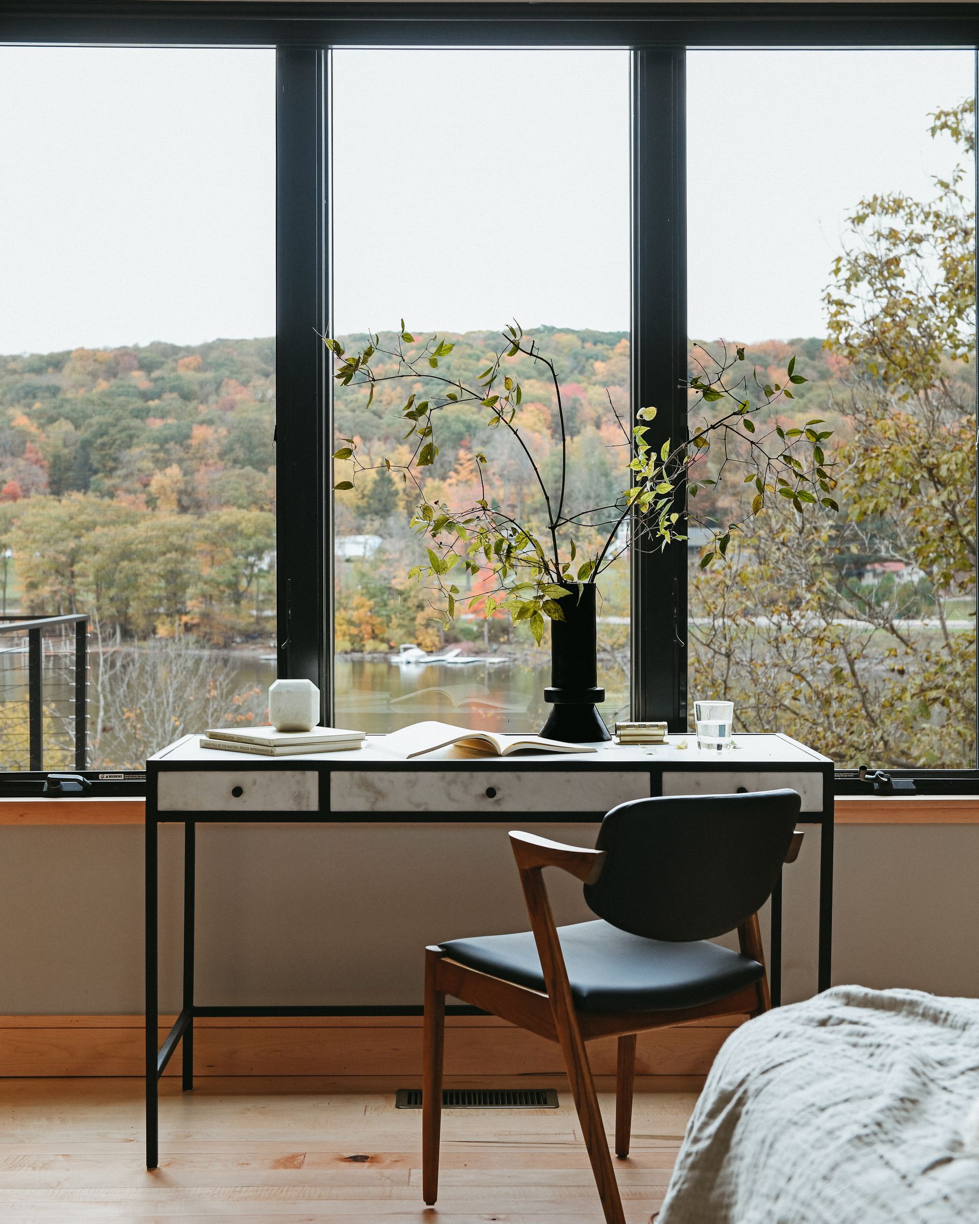 Stone Manor bedroom with a desk and chair in front of a large window.