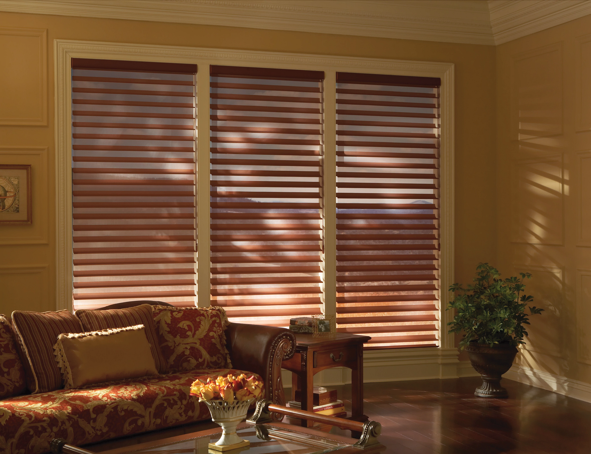 Three tall windows covered by Silhouette® Sheer Panels in a living room.