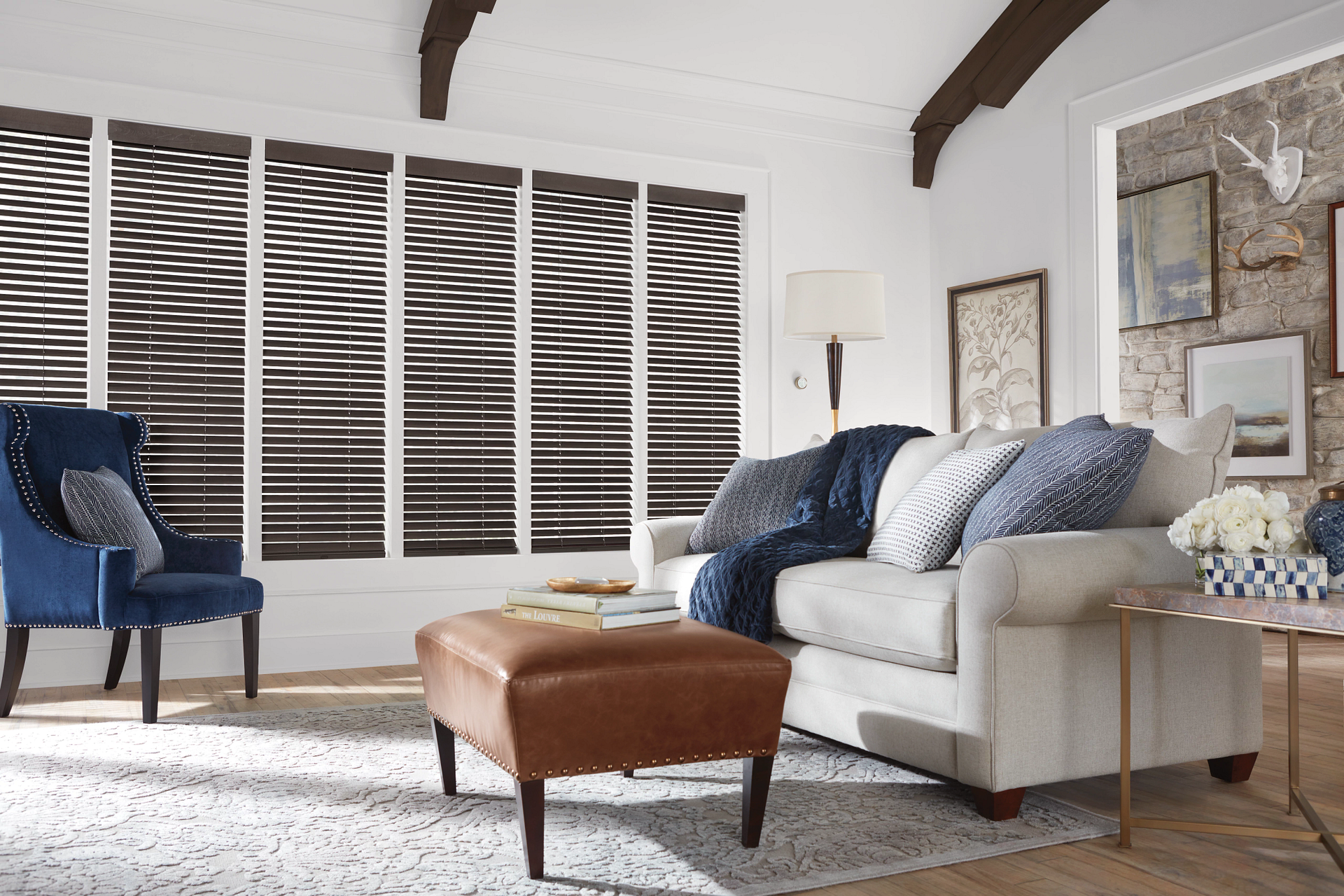 Rustic living room with furniture, decor, and Hunter Douglas wood blinds.