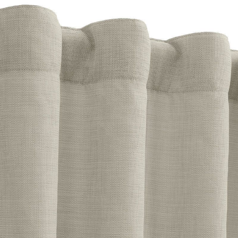 Close-up of light beige fabric curtain panels with rounded pleated tops