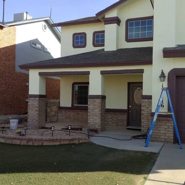 A large house with a ladder in front of it