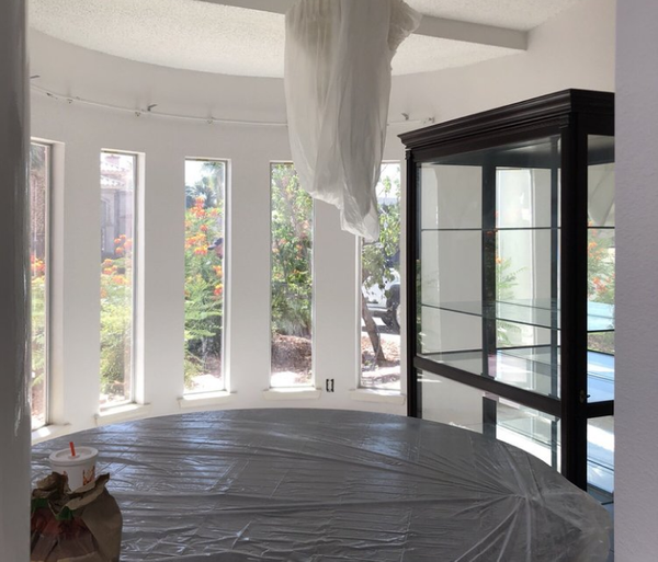 A room with a round table and a glass display case