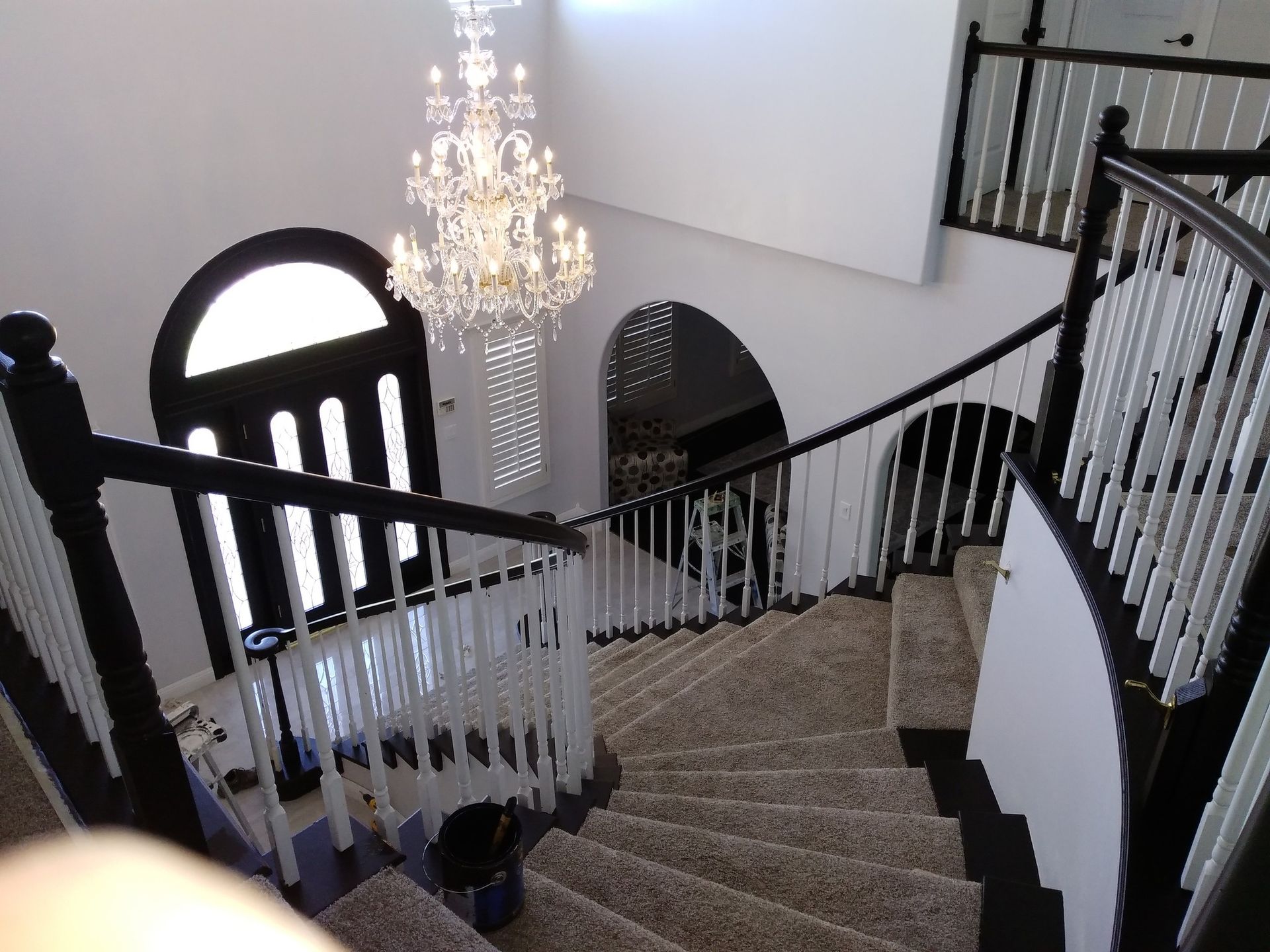 A staircase with a chandelier hanging from the ceiling