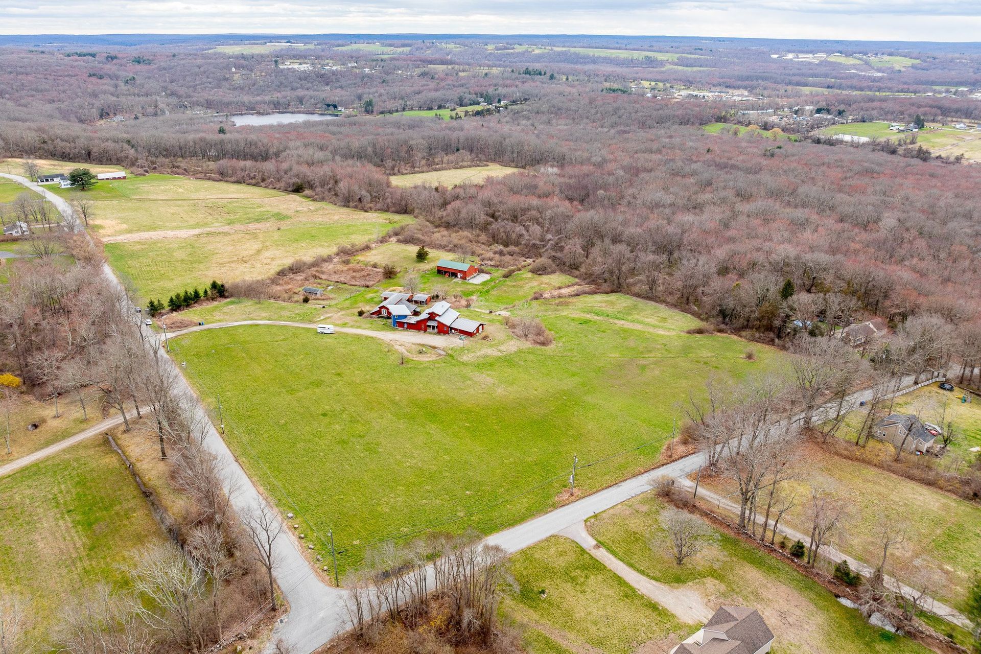 Home with stables, hay barn, pastures, hay fields, trails, paddocks & outdoor arena in CT