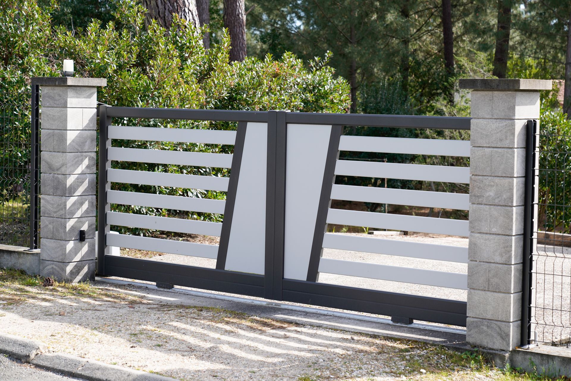 A house with a fence and a gate in front of it.