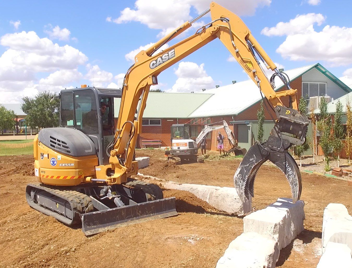machinery picking a rock