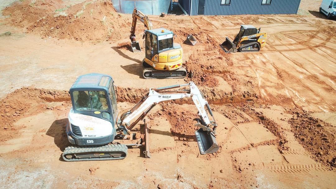 multiple machine clearing an area