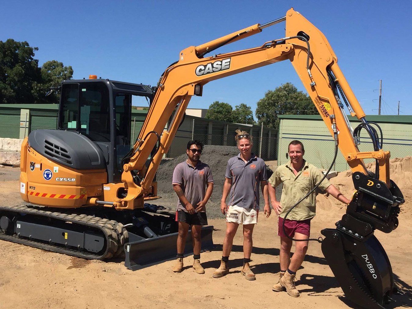 people posing beside a machine