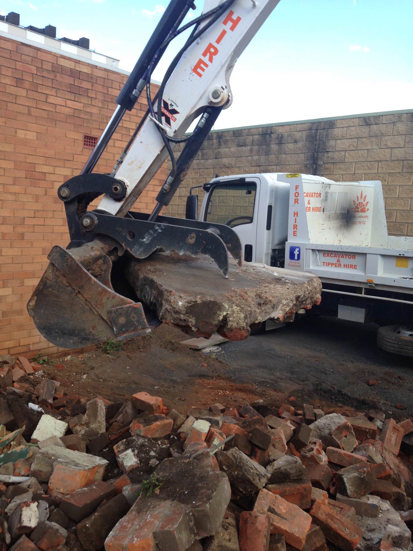 white backhoe with stone
