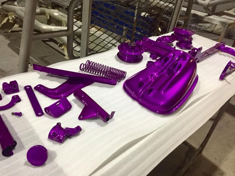 A Bunch Of Purple Parts Are Sitting On A Table — Hunter Powder & Paints In Rutherford, NSW