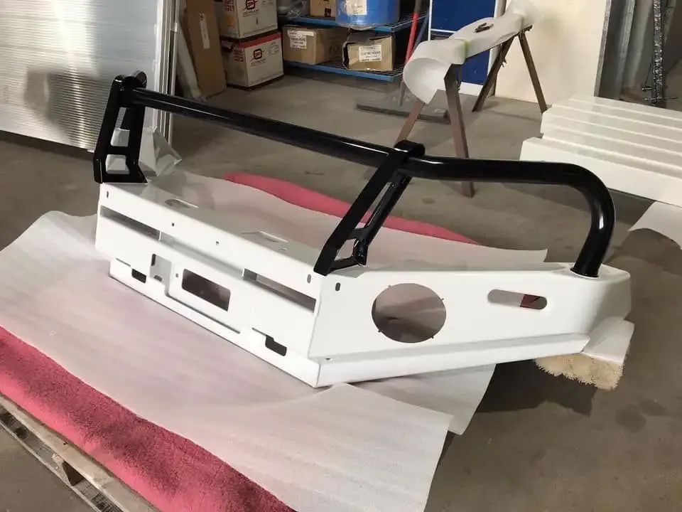 A White Bumper With A Black Bar Is Sitting On A Table — Hunter Powder & Paints In Maitland, NSW