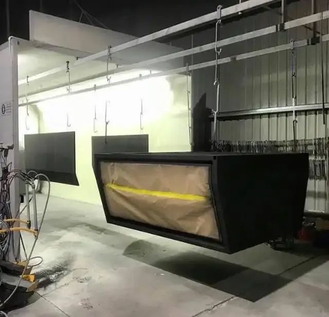 A Black Box Is Hanging From The Ceiling In A Paint Booth — Hunter Powder & Paints In Cessnock, NSW