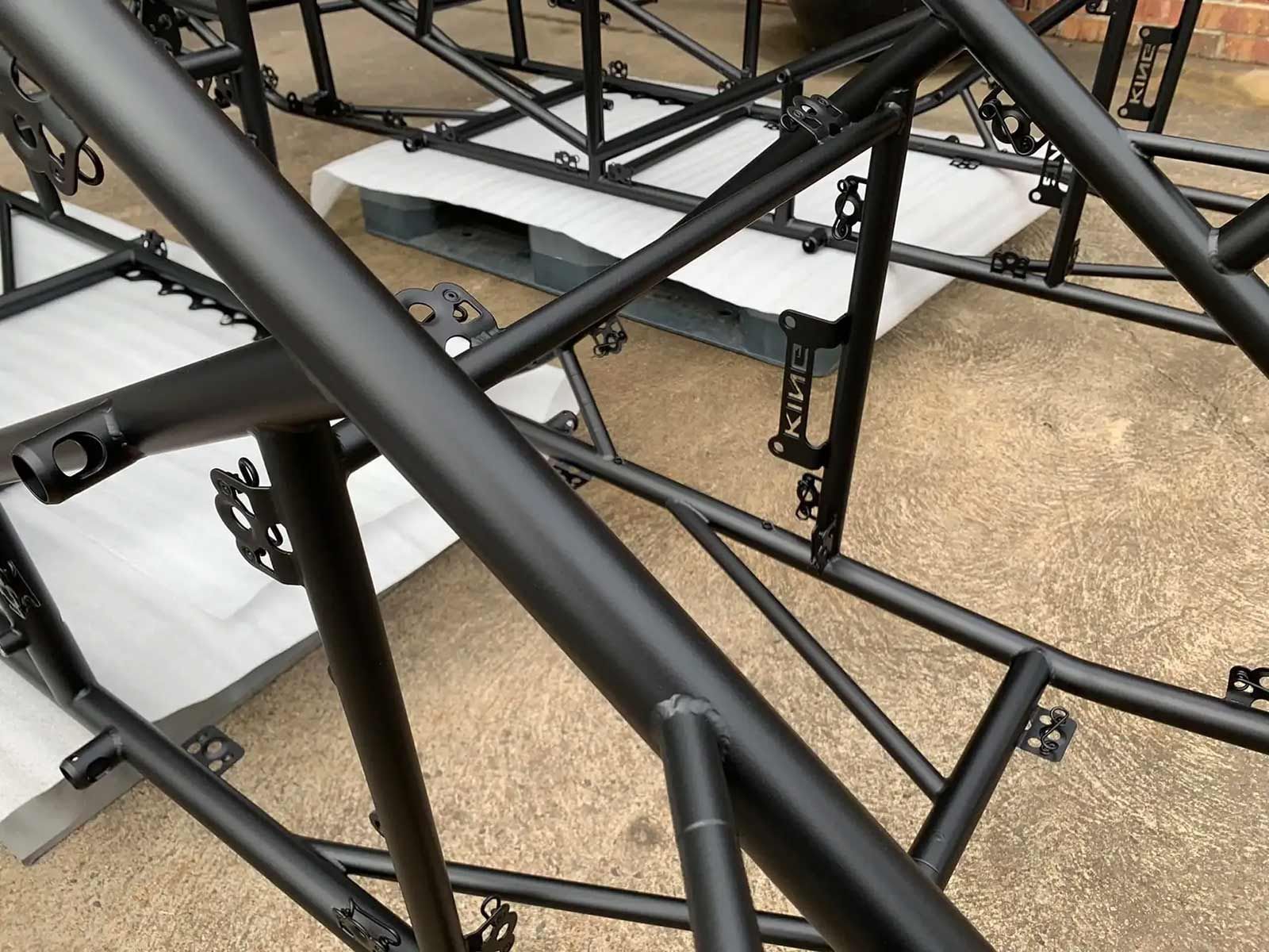 A Bunch Of Black Metal Tubes Are Stacked On Top Of Each Other — Hunter Powder & Paints In Newcastle, NSW