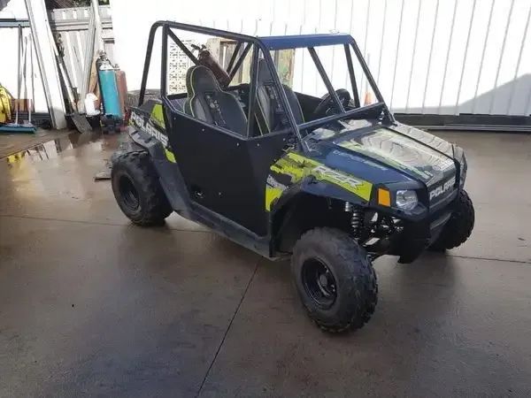 A Small ATV Is Parked On The Side Of The Road — Hunter Powder & Paints In Lake Macquarie, NSW
