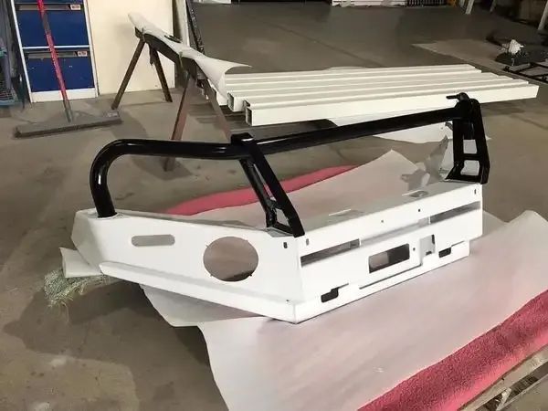 A White Bumper With A Black Bar Is Sitting On A Table — Hunter Powder & Paints In Muswellbrook, NSW