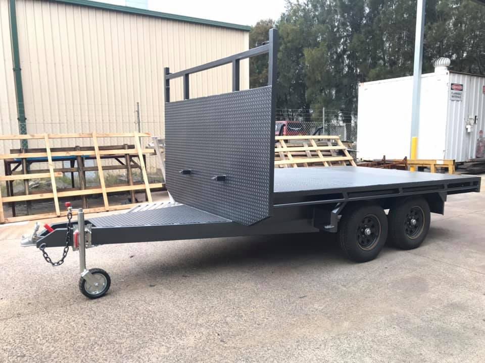 A Flatbed Trailer Is Parked In Front Of A Building — Hunter Powder & Paints In Maitland, NSW