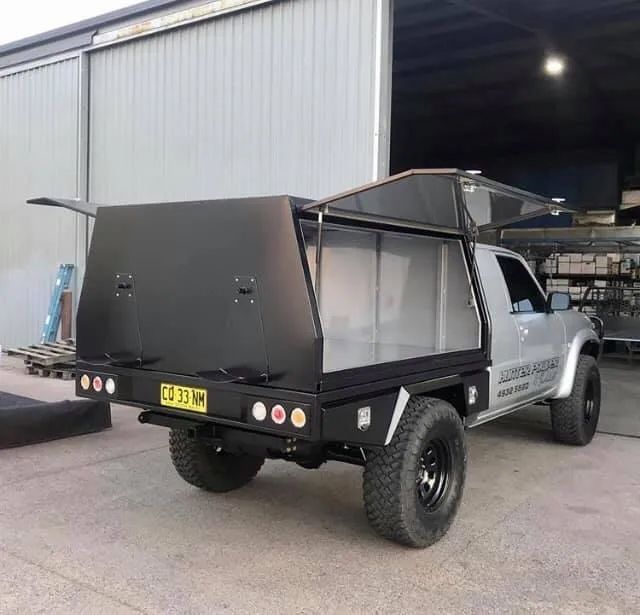 A Truck With A Canopy On Top Of It Is Parked In Front Of A Building — Hunter Powder & Paints In Rutherford, NSW