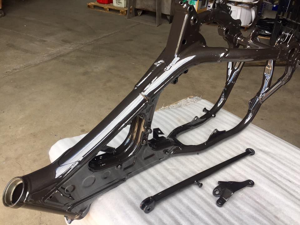 A Black Motorcycle Frame Is Sitting On A White Table — Hunter Powder & Paints In Newcastle, NSW