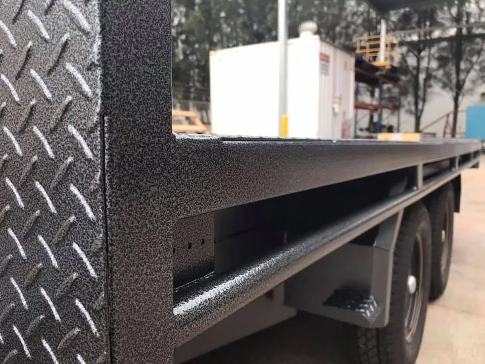 A Black Truck With A Diamond Plate On The Side Is Parked In A Parking Lot — Hunter Powder & Paints In Rutherford, NSW