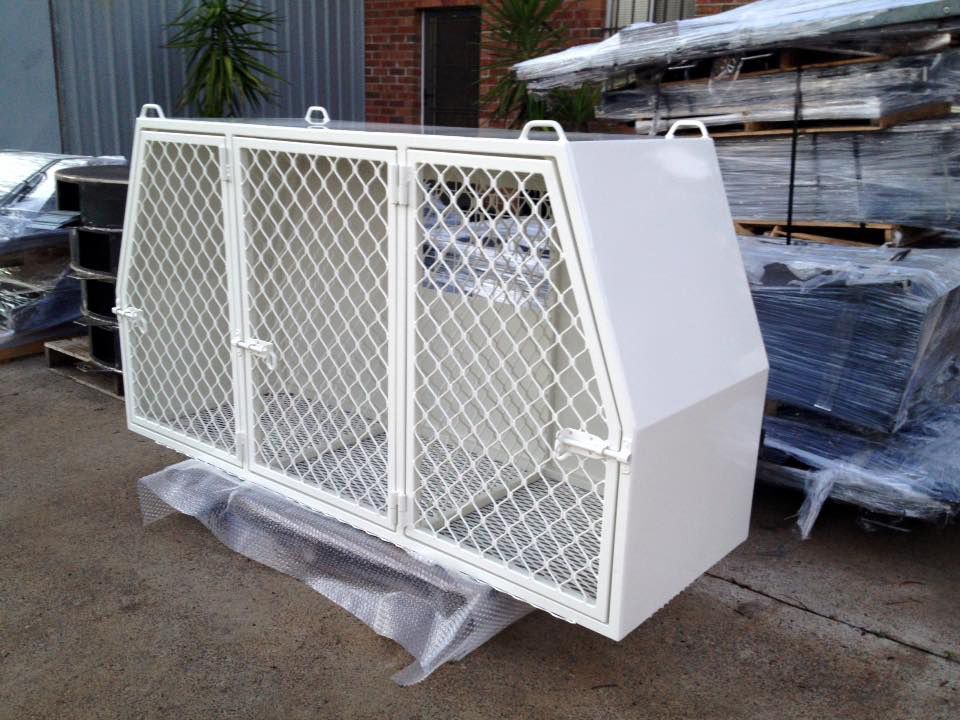 A White Cage With Mesh Doors Is Sitting On The Ground — Hunter Powder & Paints In Singleton, NSW
