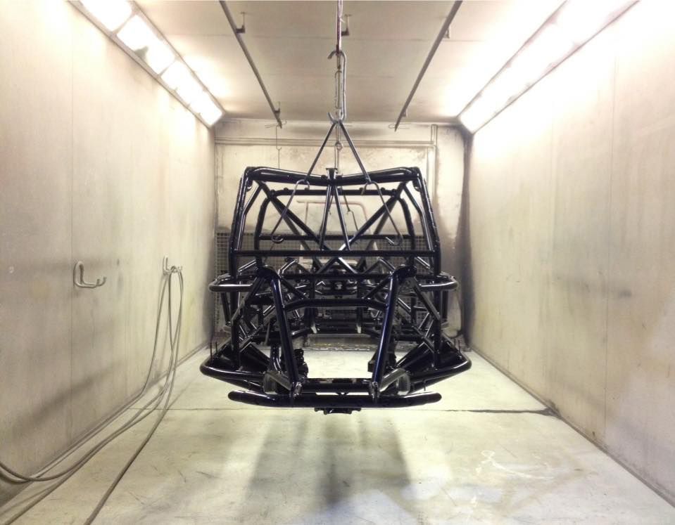 A Car Frame Is Hanging From The Ceiling In A Room — Hunter Powder & Paints In Singleton, NSW