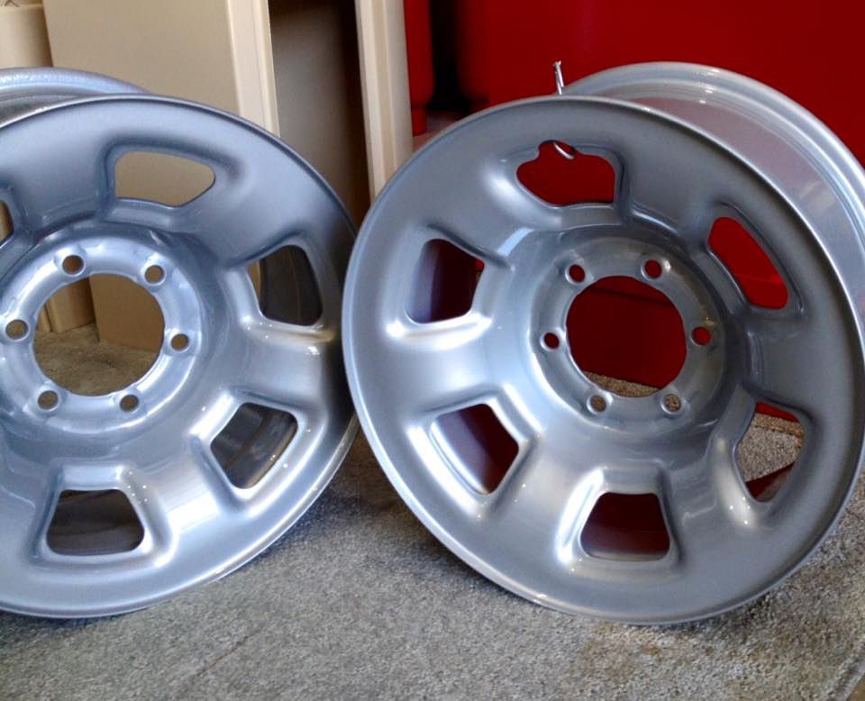 A Pair Of Silver Wheels Are Sitting On A Carpet — Hunter Powder & Paints In Singleton, NSW