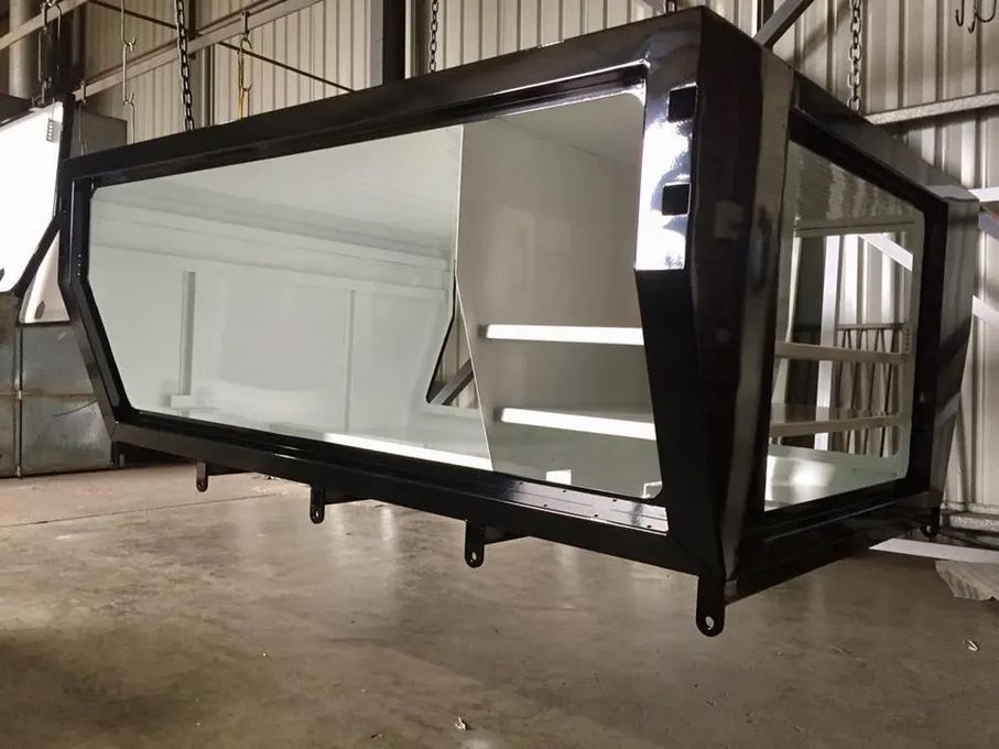 A Large Mirror Is Hanging From The Ceiling Of A Building — Hunter Powder & Paints In Rutherford, NSW