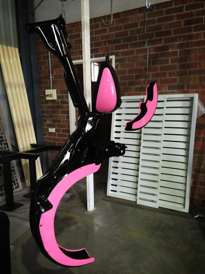 A Black And Pink Sculpture Is Hanging From The Ceiling — Hunter Powder & Paints In Central Coast, NSW