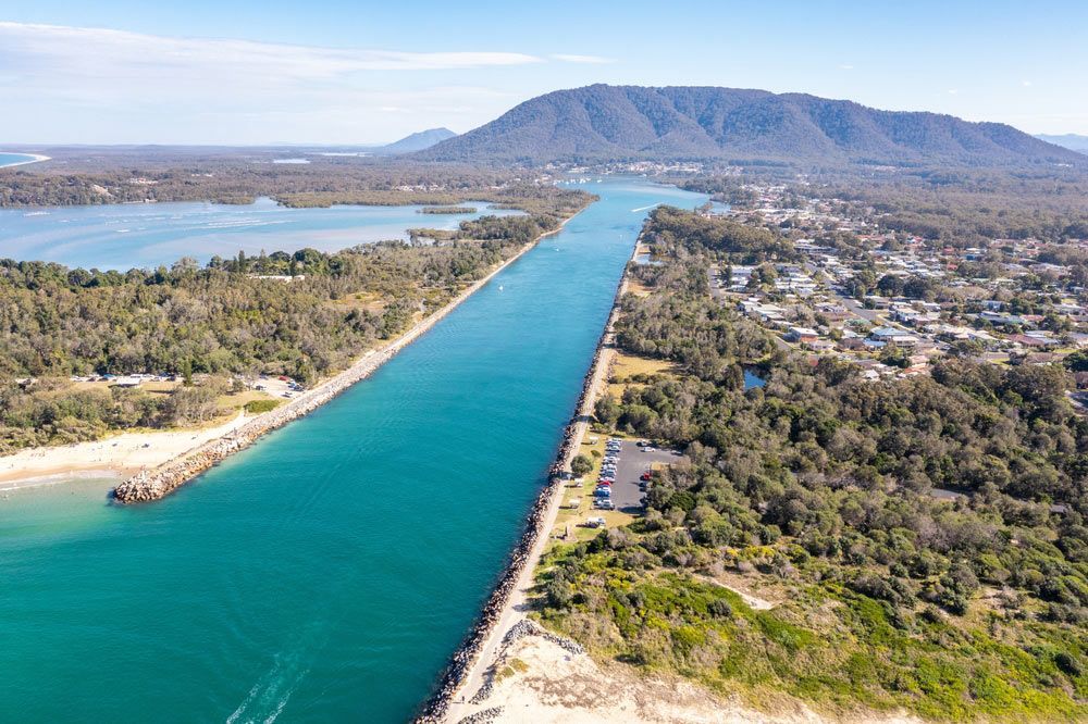 An Aerial View Of A River Surrounded By Trees And Mountains — Hunter Powder & Paints In Mid North Coast, NSW