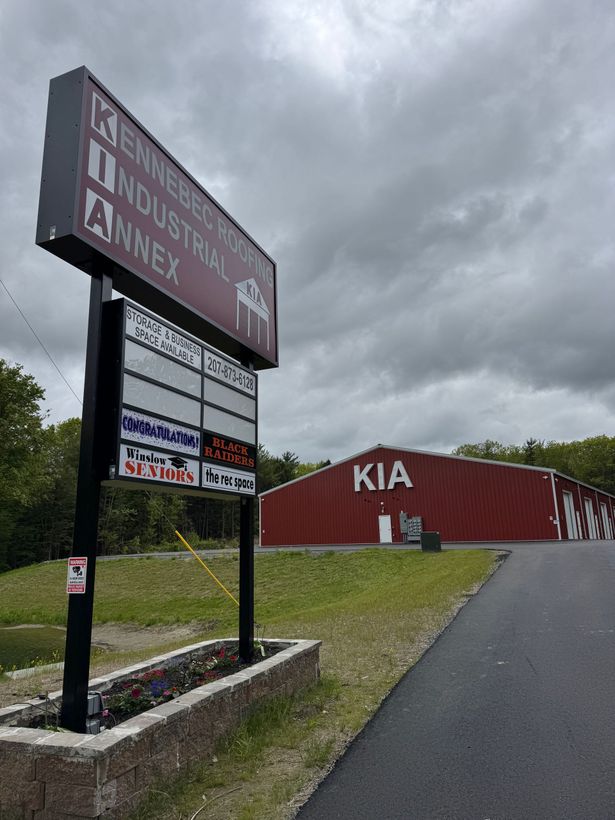 A large red building with a sign in front of it.