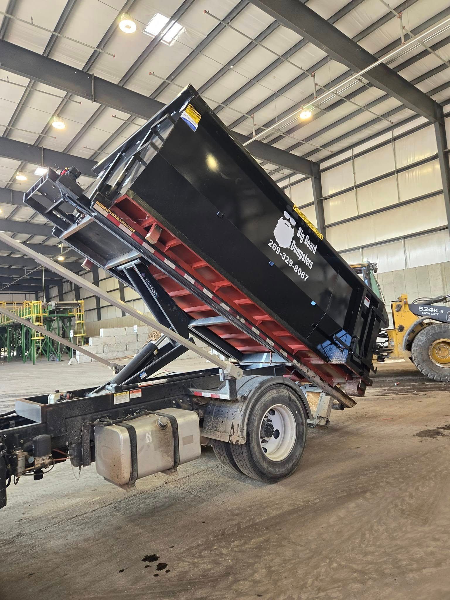 A dump truck is parked inside of a building.