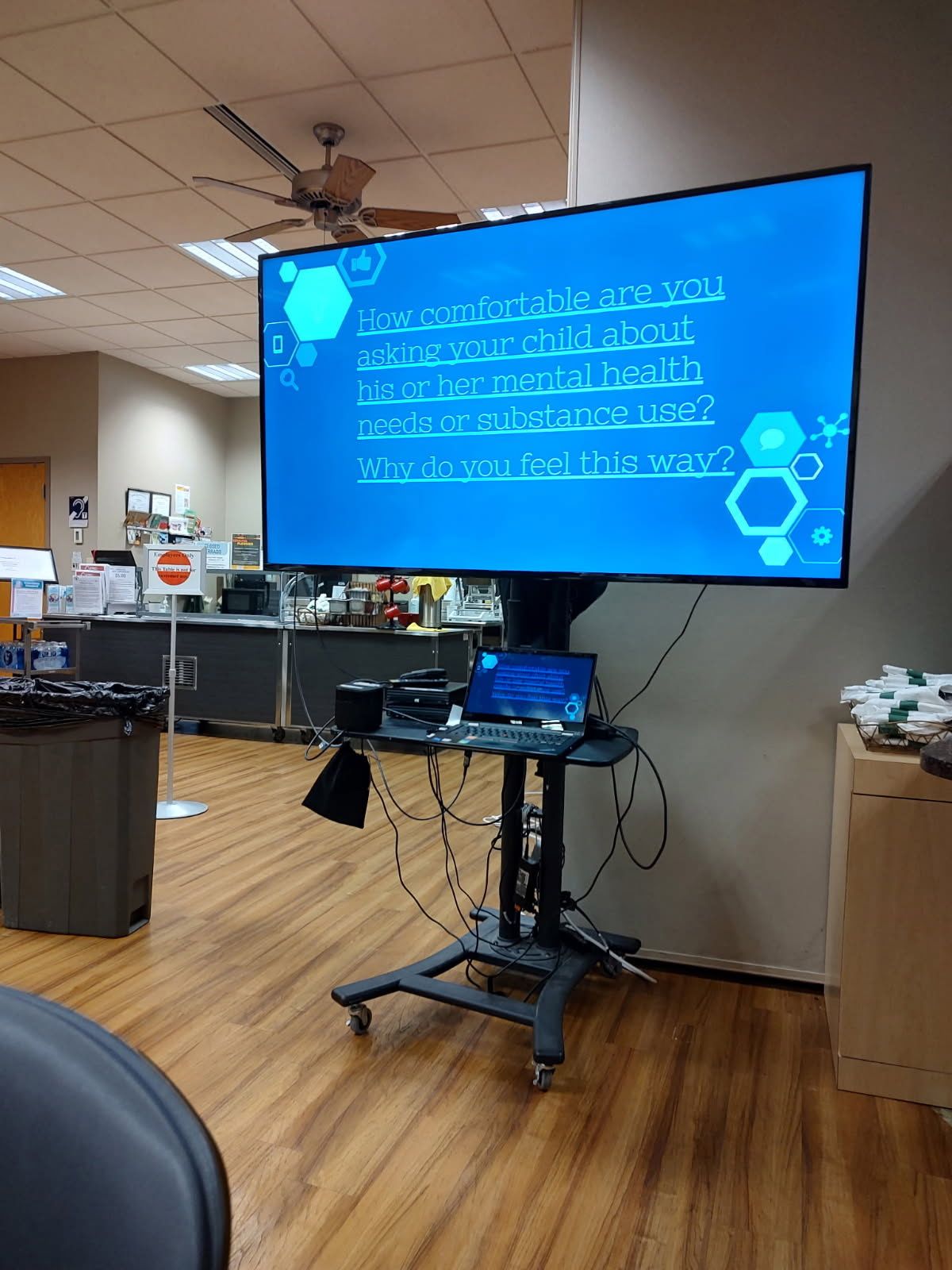 A large flat screen tv is sitting on a stand in a room.