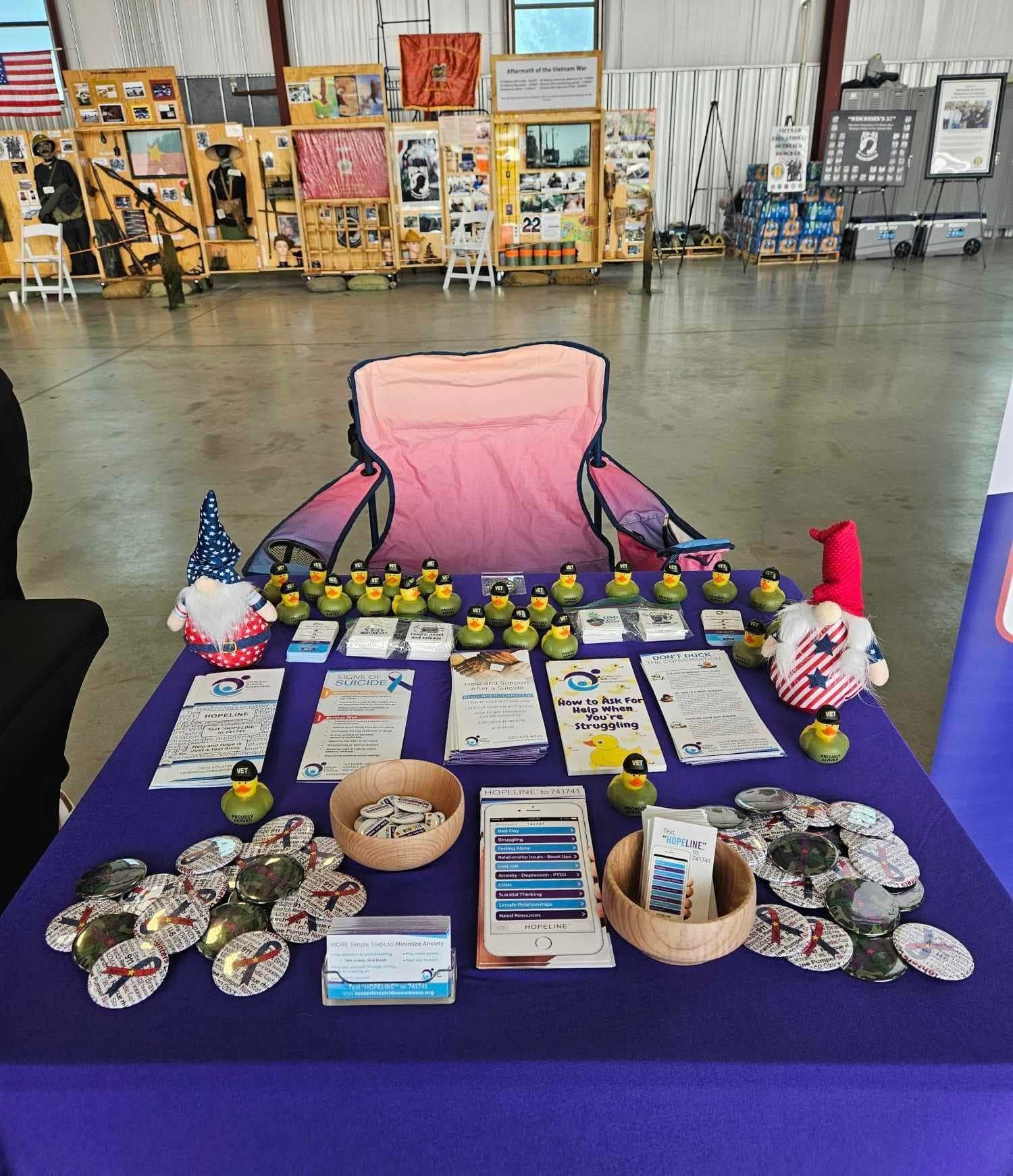 A table with a pink chair and ducks on it