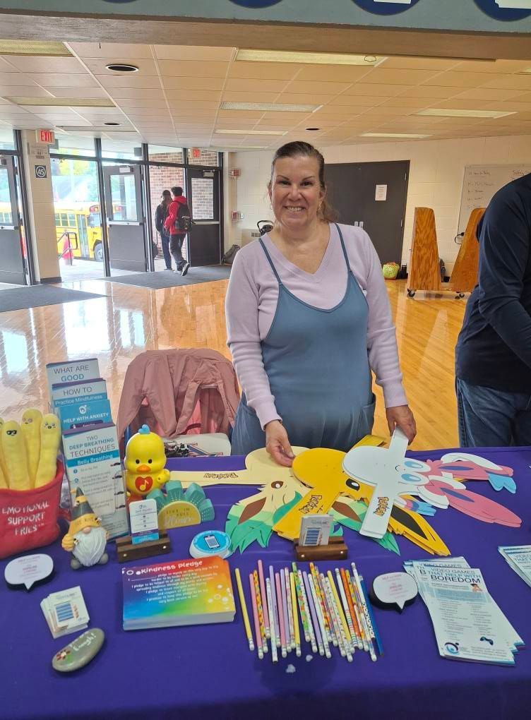 A woman is standing in front of a table with toys on it.